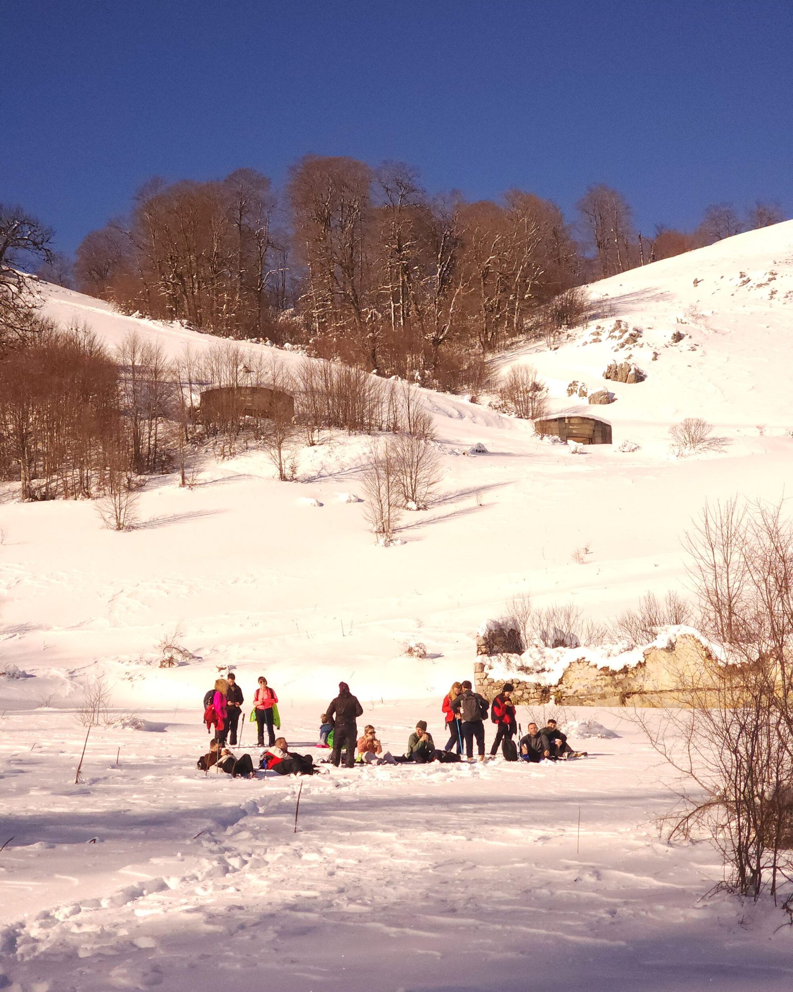 Hikers resting in snow trails, Fushe-Studen, Albania